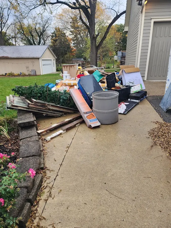 Dumpster being loaded with debris for Roofing Dumpster Rental in Brockport
